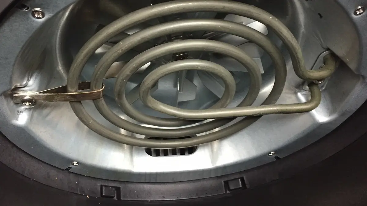 Coiled heating element and fan inside an air fryer